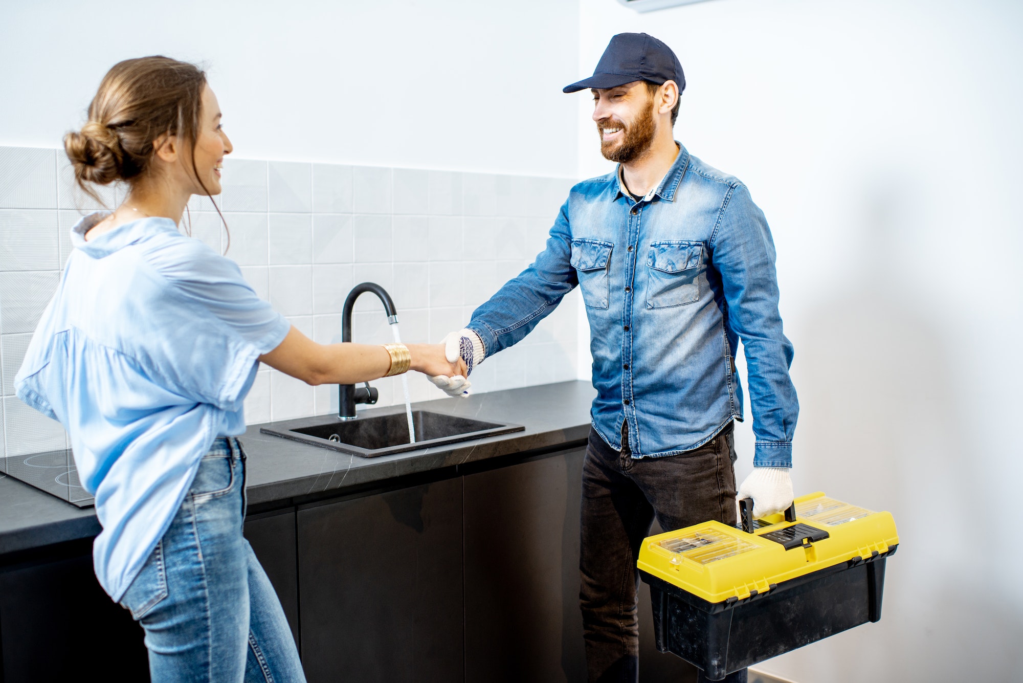 Handy man with woman on the kitchen